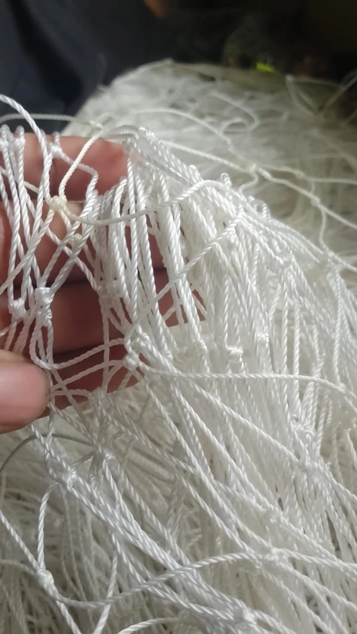 A bundle of white knotted netting ready for fitting